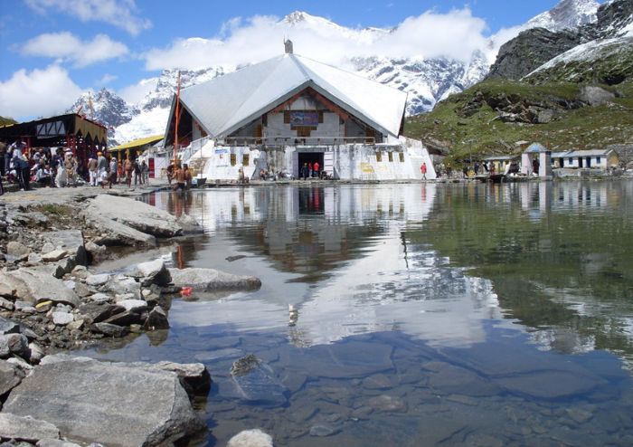 Trekkers on snow-dusted paths to shrine